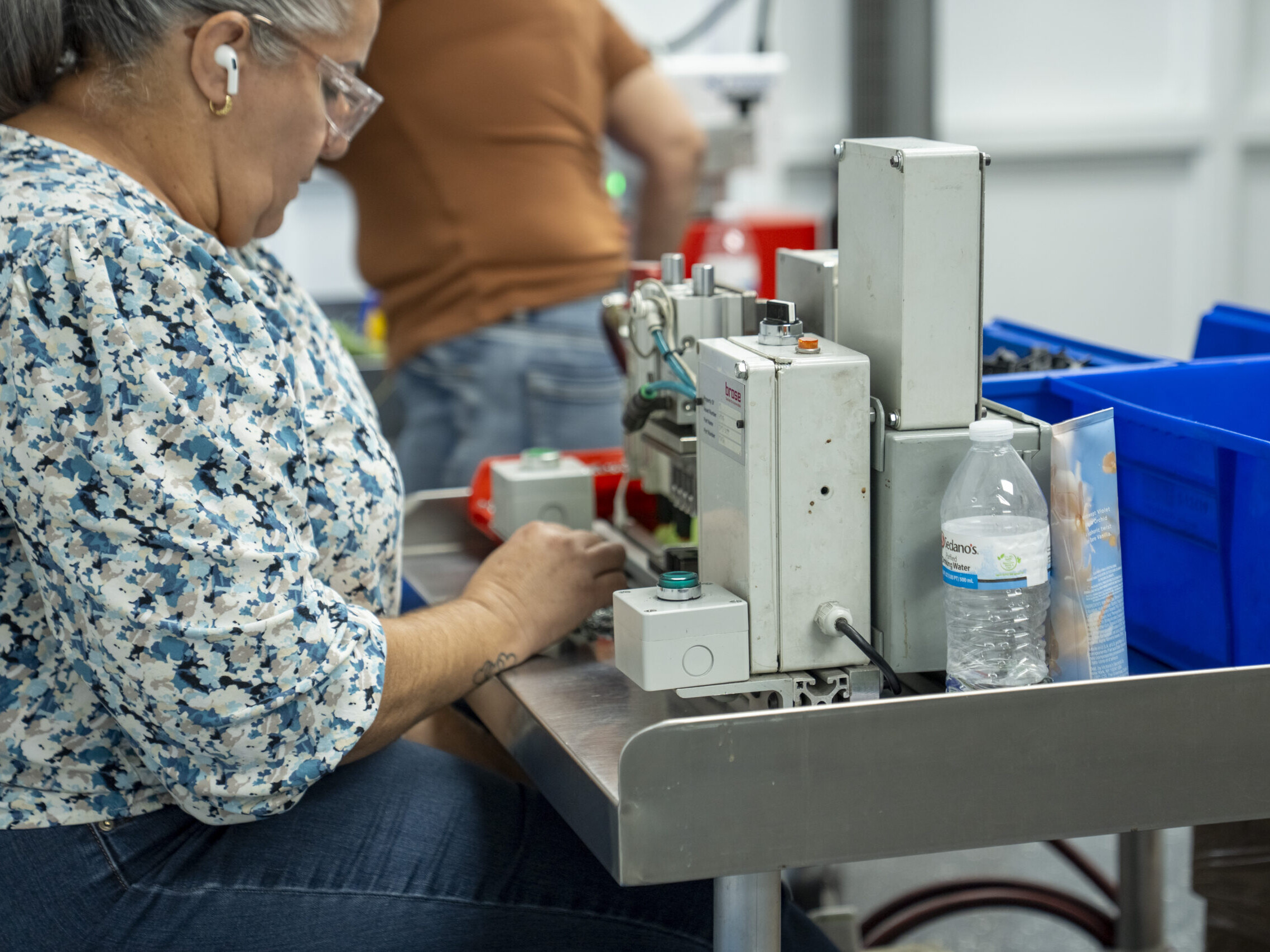 woman working on industrial plastic part
